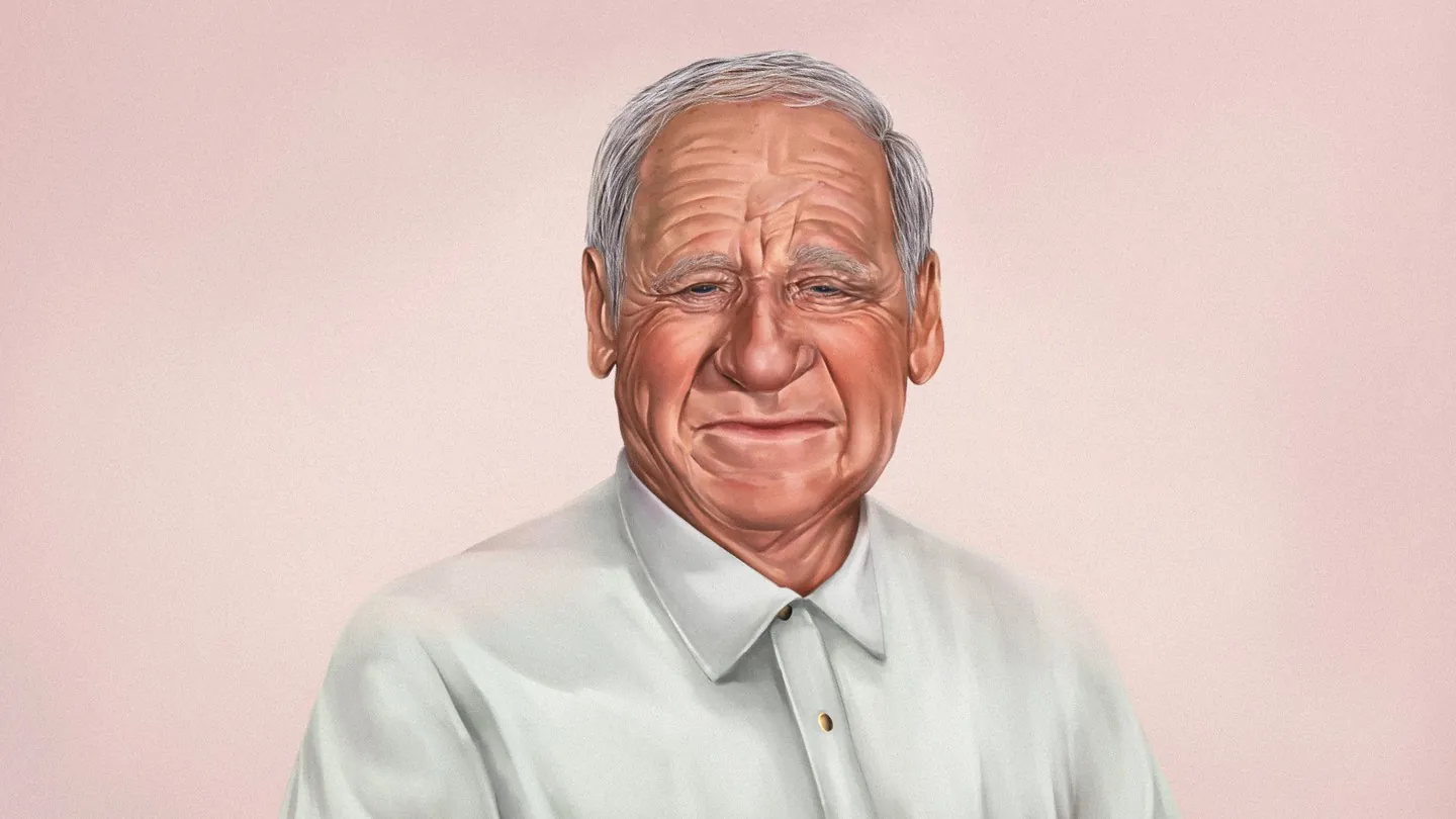 Mel Brooks in his nineties, centered against a muted studio backdrop